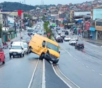 FIORINO ESCAPA DE CABO DE AÇO DE GUINCHO, BATE EM VAN E VEÍCULO FICA INCLINADO SOBRE CANTEIRO NA AVENIDA LUIZ PEQUINI